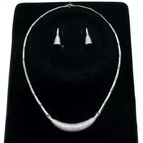Rhodium CZ Jewelry Set with rhodium-plated necklace and cubic zirconia earrings on black display