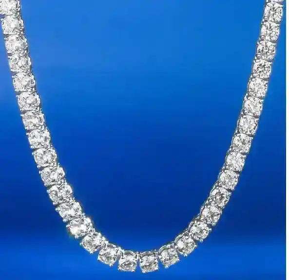 Gold 3 mm CZ Tennis Chain with sparkling cubic zirconia stones on gold-tone brass against blue background