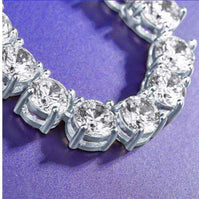 Close-up of gold 3 mm CZ tennis chain with sparkling cubic zirconia stones on purple background