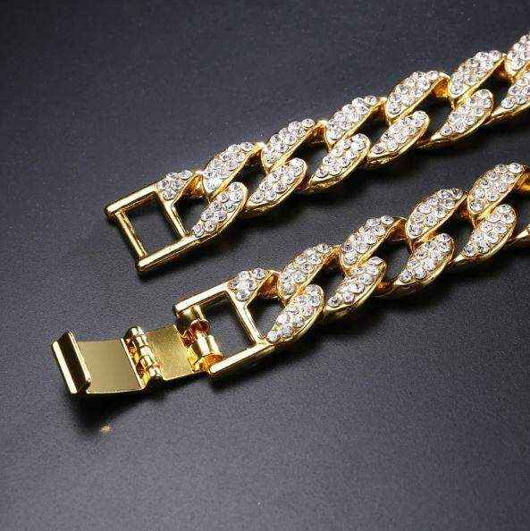 Gold Crystal Cuban Chain 8mm wide gold plated solid brass links with sparkling rhinestone crystals and fold-over clasp on black background