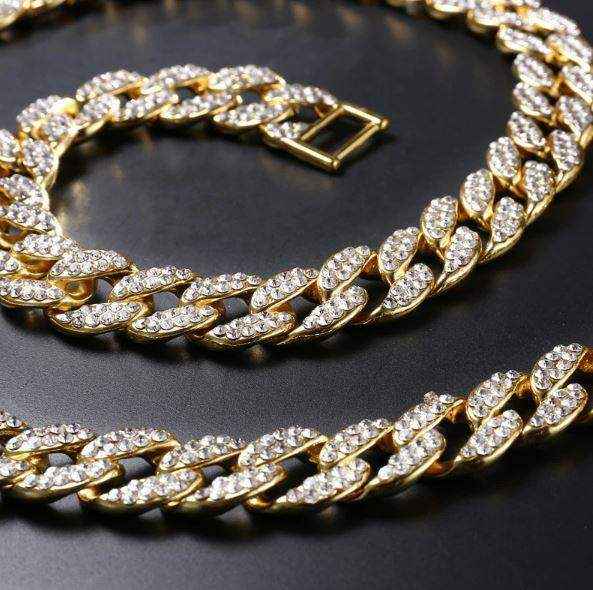 Gold Crystal Cuban Chain 8mm wide with 14K yellow gold plating and sparkling crystal iced links on black background