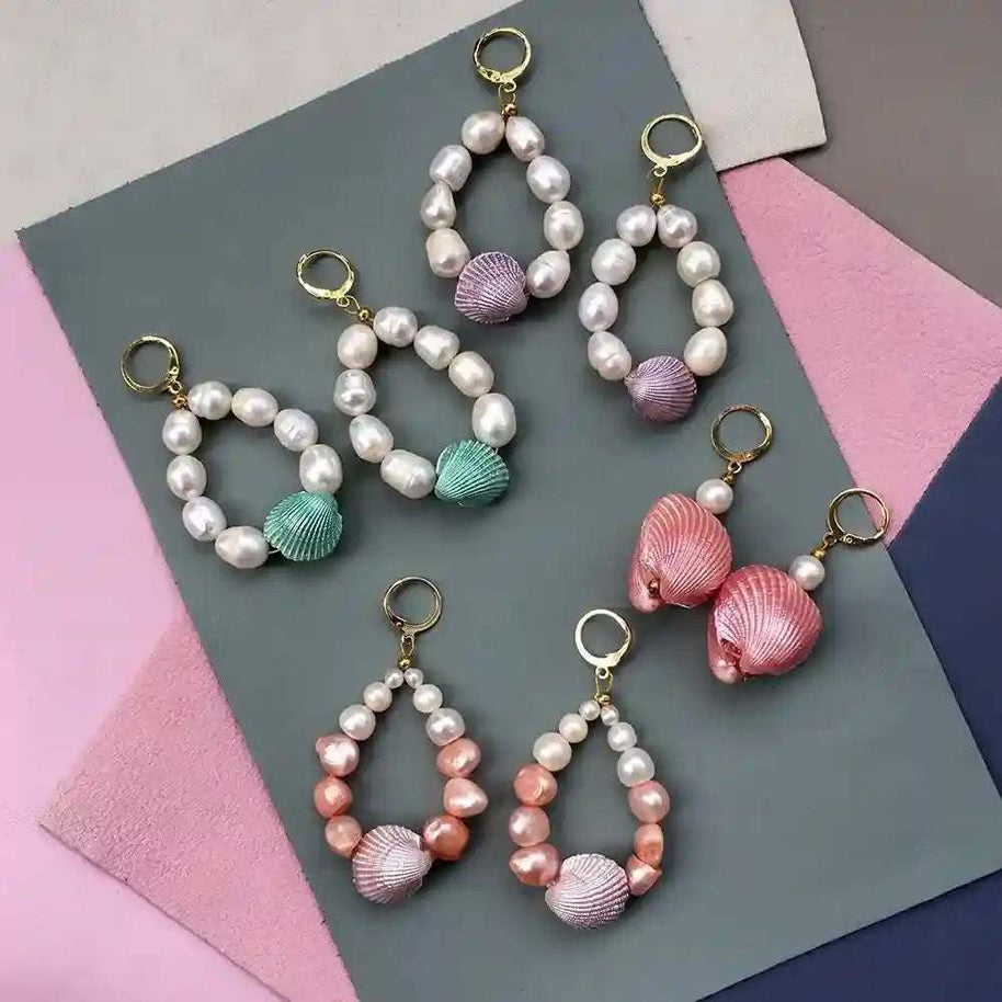 Candy Shell Pearl Earrings featuring pastel clamshell charms and freshwater-style pearls on 24K gold-plated hoops in various colors