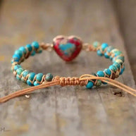 Imperial Jasper Macrame Bracelet with turquoise beads and adjustable lace-up closure on rustic wood background