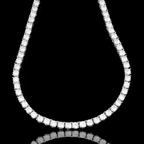 Gold 3 mm CZ tennis chain with prong-set cubic zirconia stones on black background