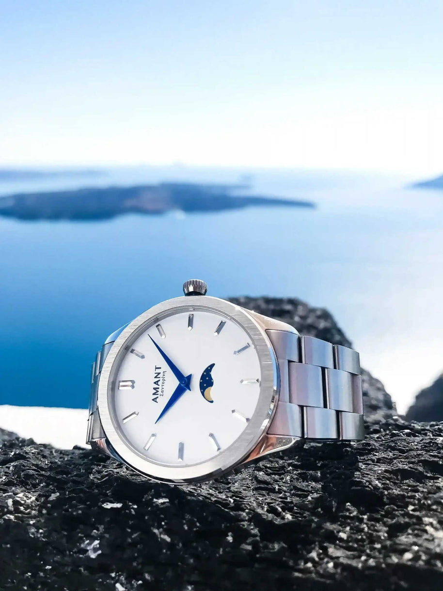 Santorini Moonphase Watch with stainless steel band and moonphase dial on rocky surface by the sea