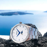 Santorini Moonphase Watch with stainless steel band and moonphase dial on rocky surface by the sea