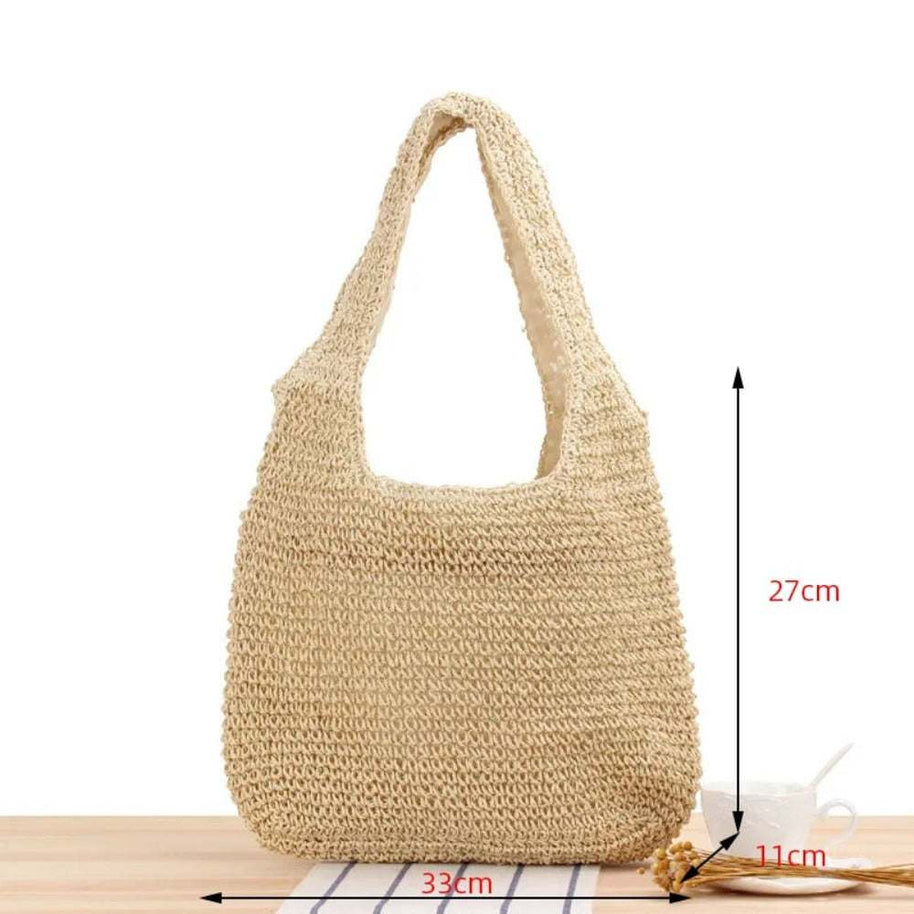 Casual summer shoulder beach bag made of straw with a roomy interior and soft texture for stylish beach days