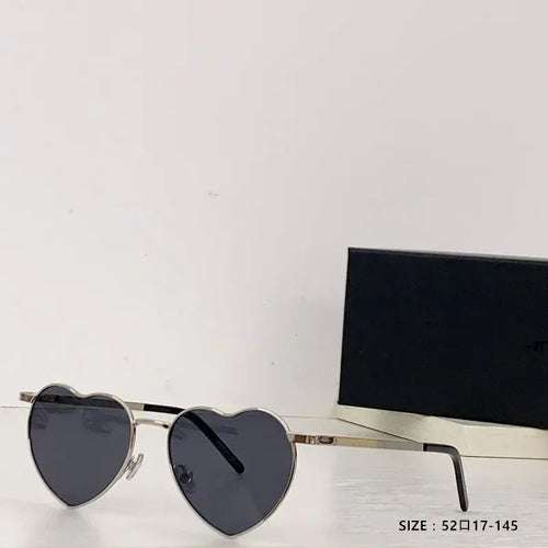 Heart a luv sunglasses with heart-shaped black lenses and gold acetate frame, UV400 protected and photochromic lenses.