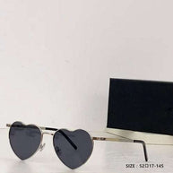 Heart a luv sunglasses with heart-shaped black lenses and gold acetate frame, UV400 protected and photochromic lenses.