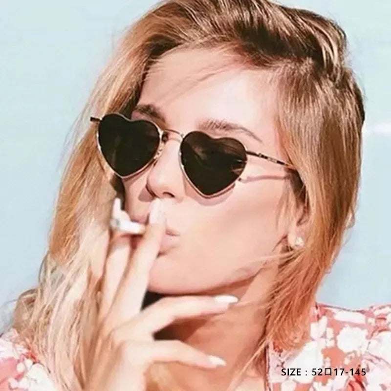 Woman wearing Heart a luv sunglasses with heart-shaped black lenses and thin metal frames