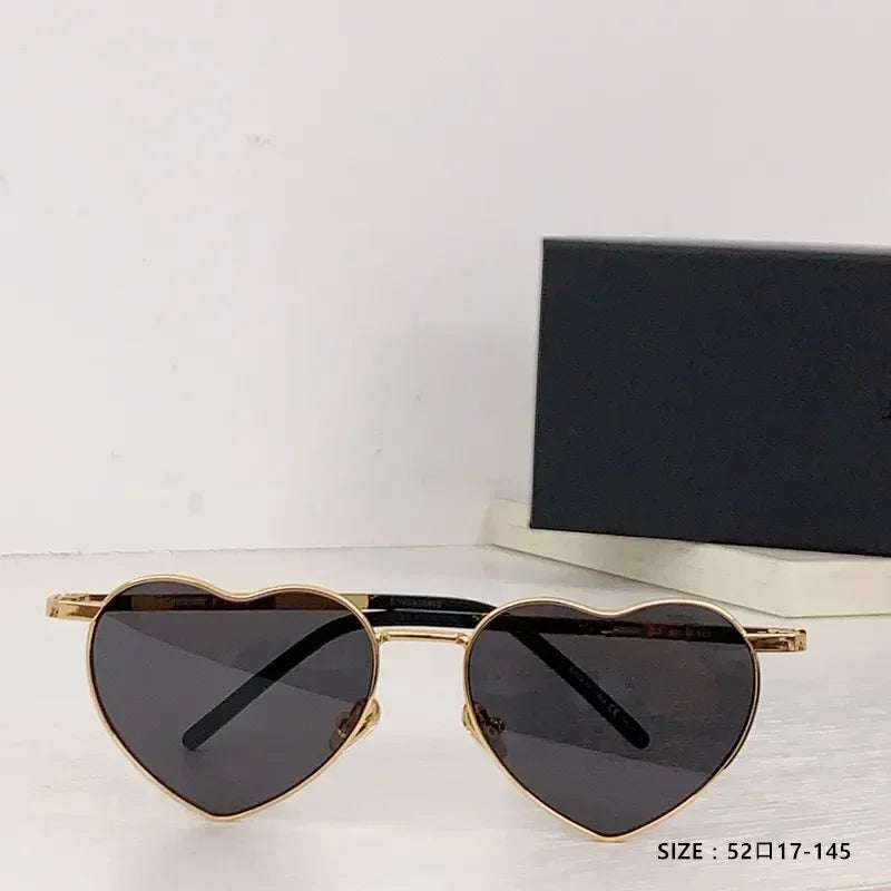 Heart a luv sunglasses with heart-shaped dark lenses and gold acetate frames, UV400 protected and anti-reflective.
