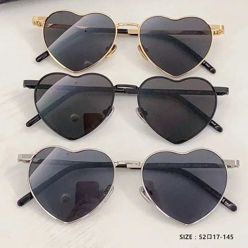 Heart a luv sunglasses in gold, black, and silver heart-shaped frames with dark photochromic lenses