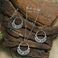 Rustic Tribal Stone Set with turquoise stones and antique silver finish necklace and earrings on wooden background
