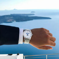 Santorini Moonphase Watch on wrist showing moonphase dial, stainless steel band, overlooking sea view