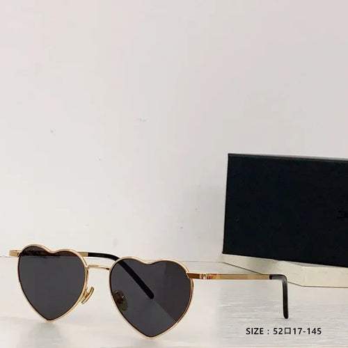 Heart a luv sunglasses with gold heart-shaped frames and dark lenses, UV400 protected and photochromic by Sexikinis Swim.