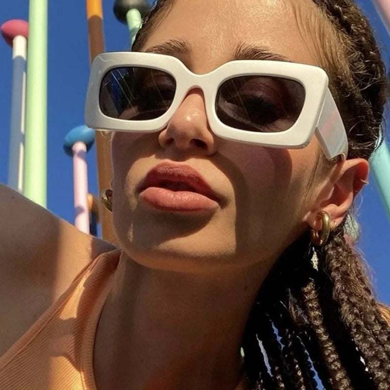 Woman wearing white vintage rectangle sunglasses with UV400 resin lenses outdoors