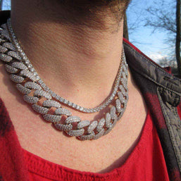 Stallion Iced 18 mm Cuban Chain with sparkling cubic zirconia on a person wearing a red shirt and jacket outdoors