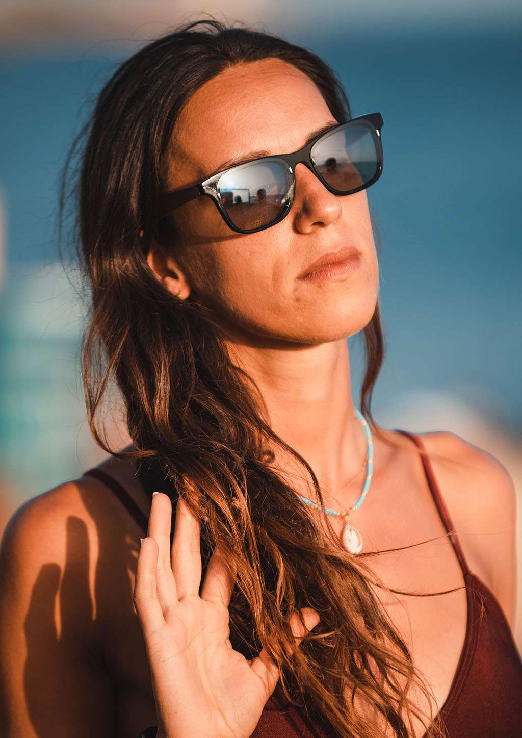 Eyewood ReInvented square acetate and walnut wood sunglasses with polarized UV400 lenses worn by woman outdoors