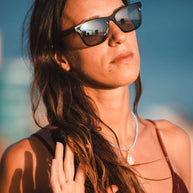 Eyewood ReInvented square acetate and walnut wood sunglasses with polarized UV400 lenses worn by woman outdoors
