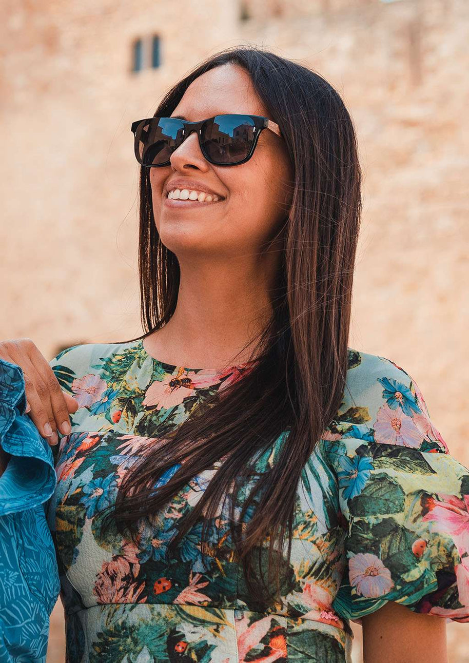 Eyewood ReInvented square acetate and walnut wood sunglasses with polarized lenses worn by woman outdoors
