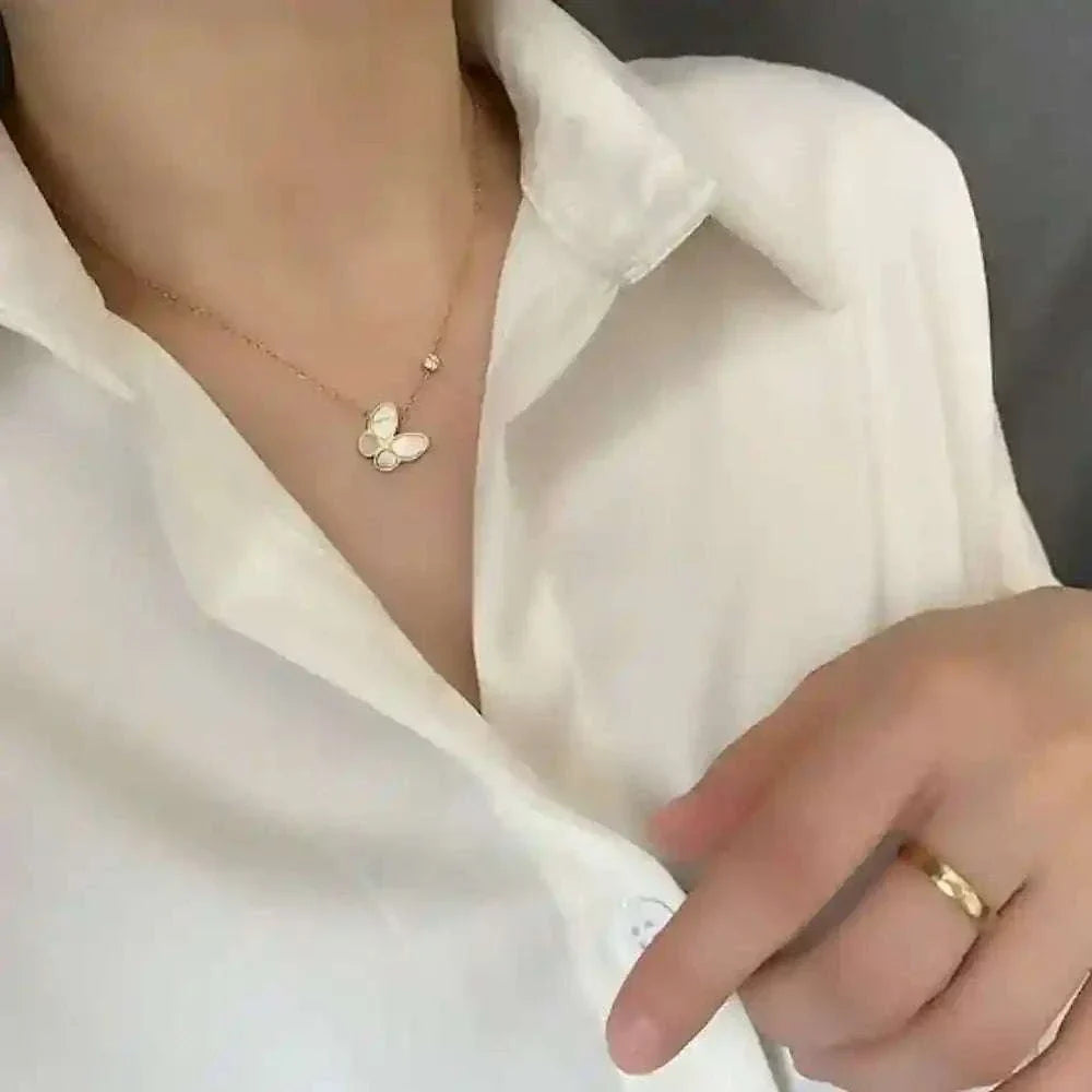 Butterfly Mother-of-Pearl Necklace with gold-plated chain on a woman wearing a white blouse