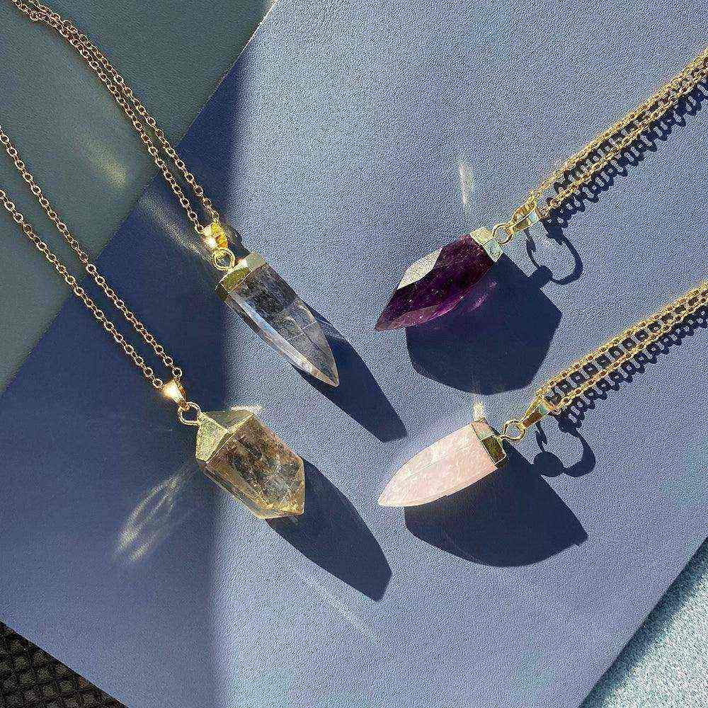 Glow Crystal Quartz Necklace collection featuring gold-plated chains with crystal quartz, rose quartz, amethyst, and smoky quartz pendants