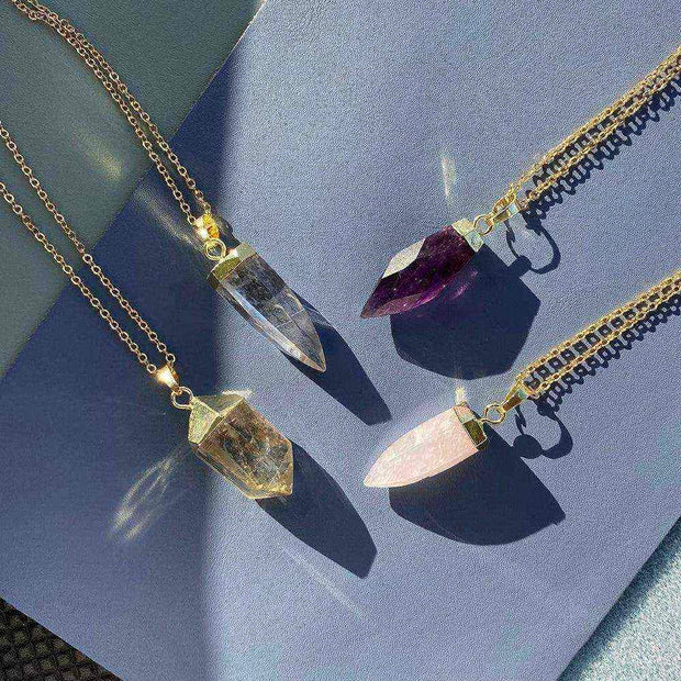 Glow Crystal Quartz Necklace collection featuring gold-plated chains with crystal quartz, rose quartz, amethyst, and smoky quartz pendants