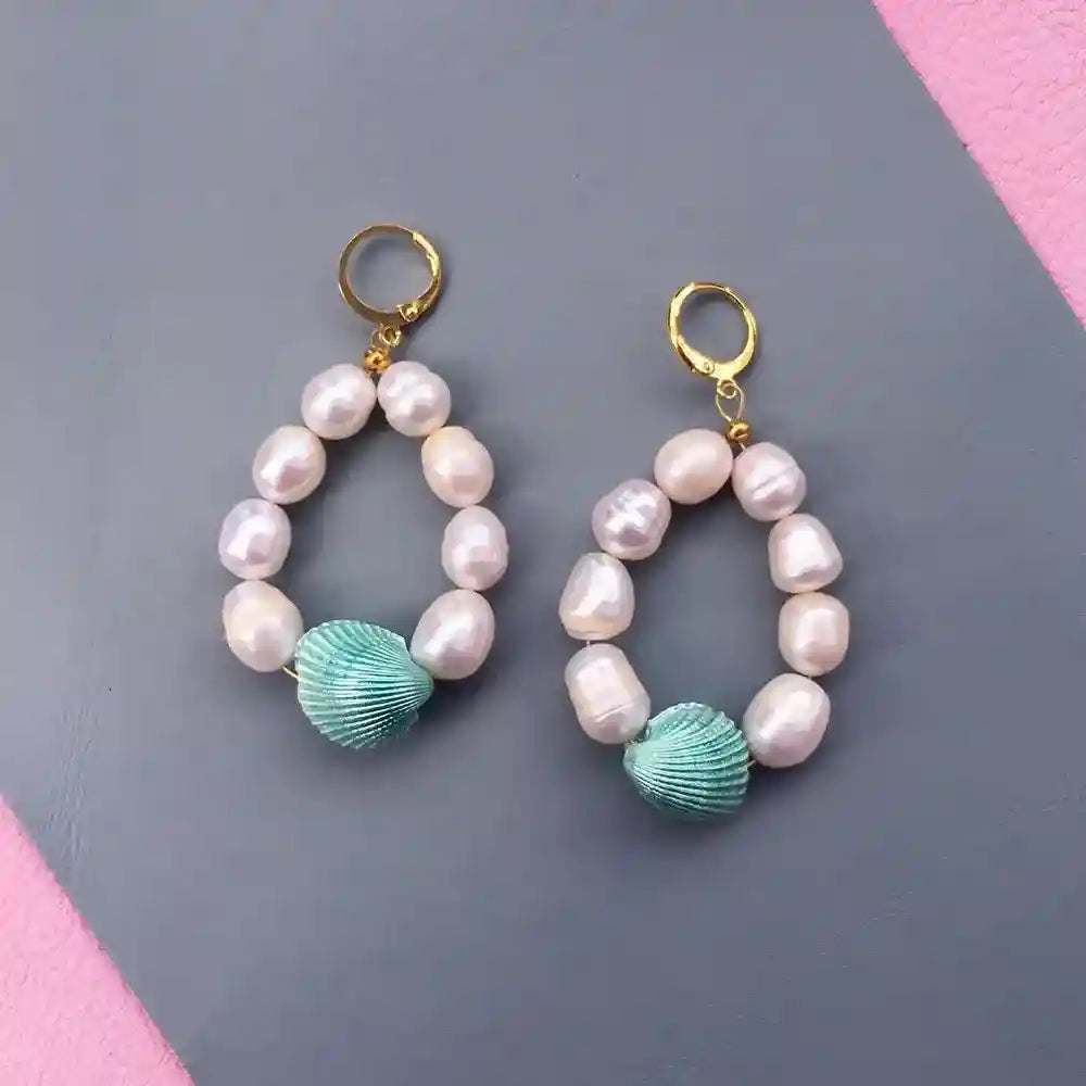 Candy Shell Pearl Earrings with gold hoops, pastel green clamshells, and freshwater pearls on gray background