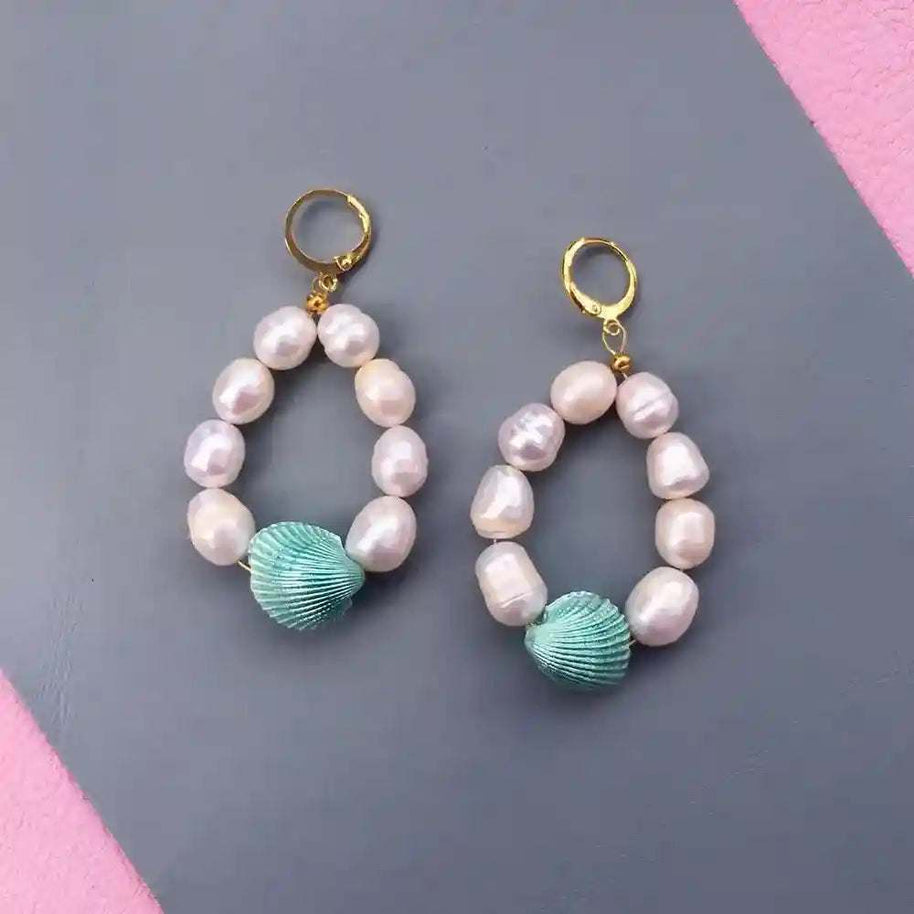 Candy Shell Pearl Earrings with gold hoops, pastel green clamshells, and freshwater pearls on gray background