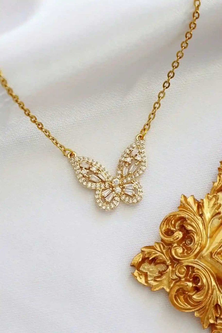 Elegant 24K gold butterfly necklace with intricate cubic zirconia detailing on a delicate chain