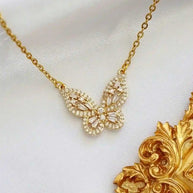 Elegant 24K gold butterfly necklace with intricate cubic zirconia detailing on a delicate chain