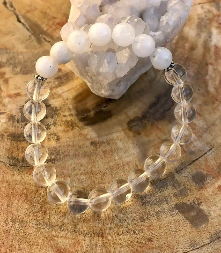 Rainbow Moonstone Stretch Bracelet with clear crystal quartz beads on stretch cord displayed on wooden surface