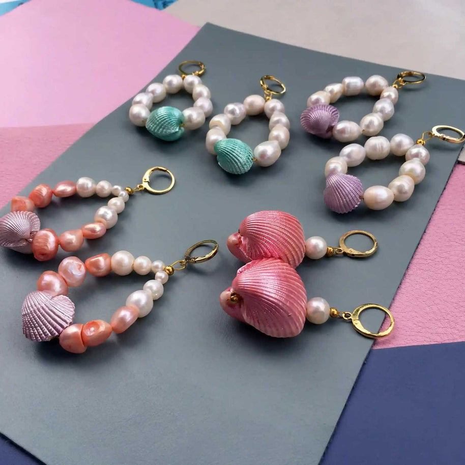 Candy Shell Pearl Earrings with pastel-colored clamshells, freshwater pearls, and 24K gold-plated hoops in a lightweight, handcrafted design