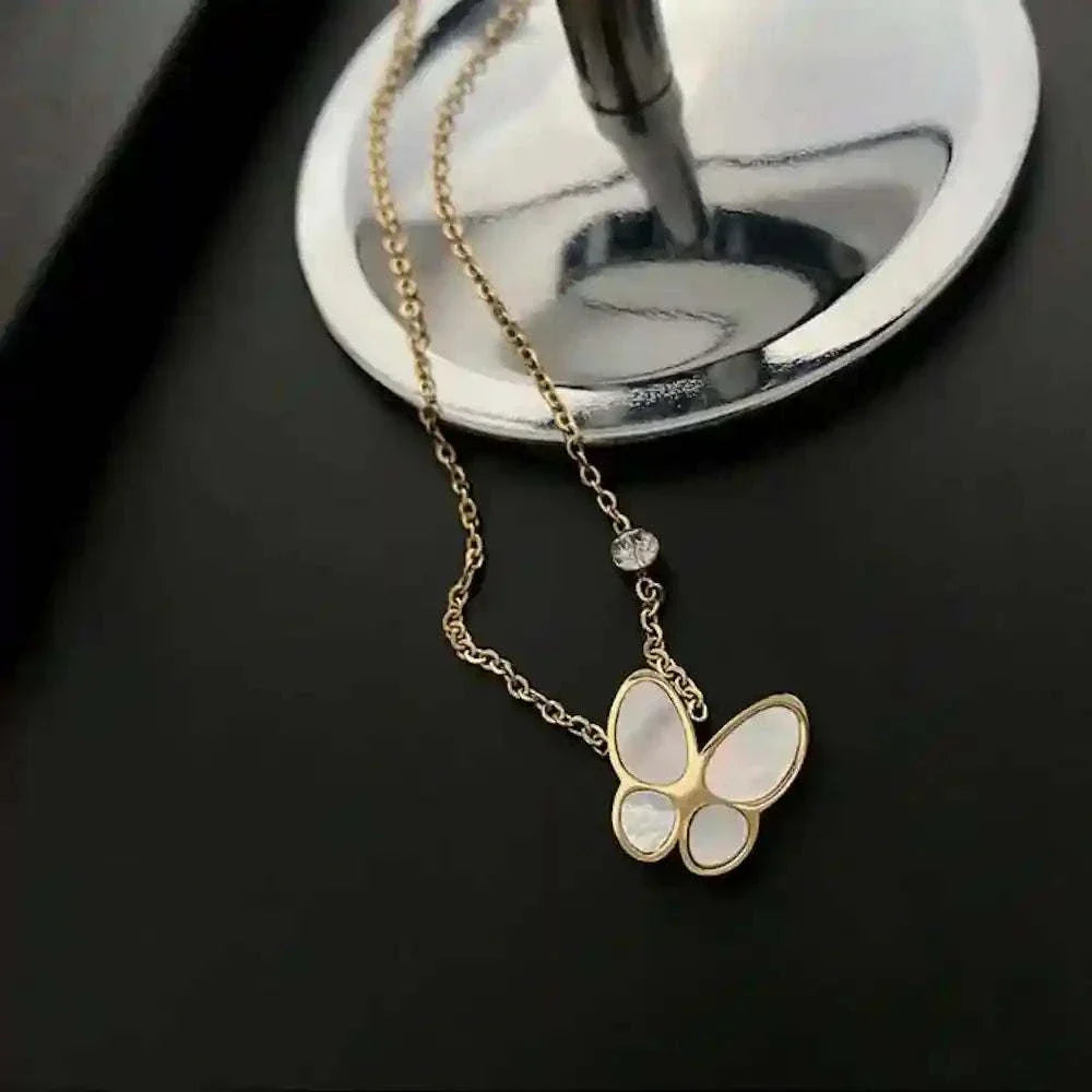 gold-plated Butterfly Mother-of-Pearl Necklace with iridescent butterfly pendant on black background