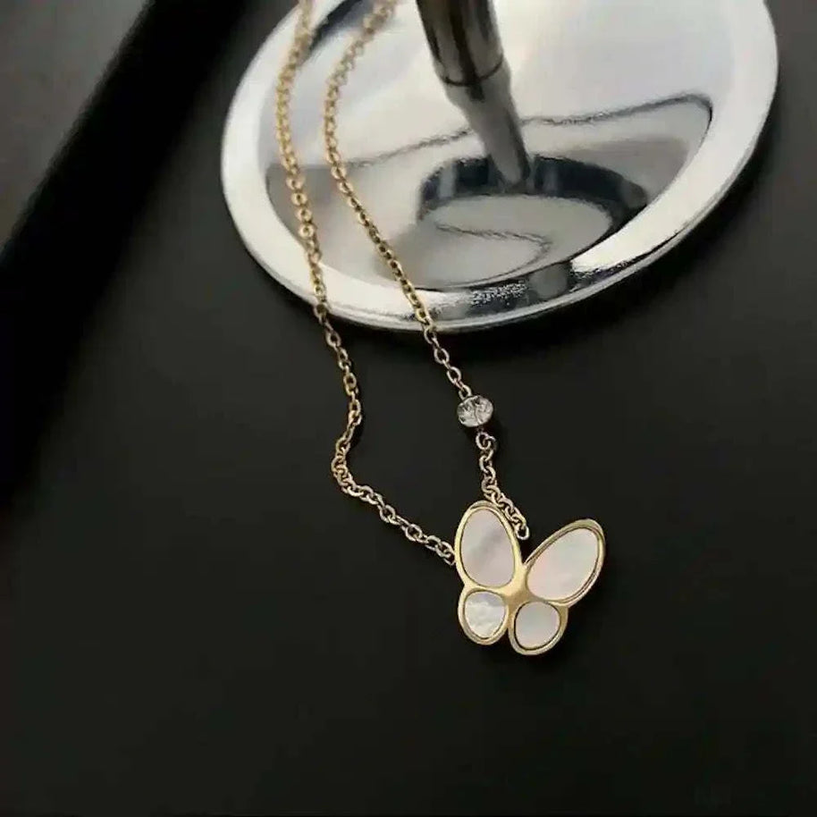 gold-plated Butterfly Mother-of-Pearl Necklace with iridescent butterfly pendant on black background
