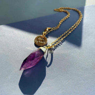 Glow Crystal Quartz Necklace with gold-plated amethyst pendant and signature tag on a delicate chain