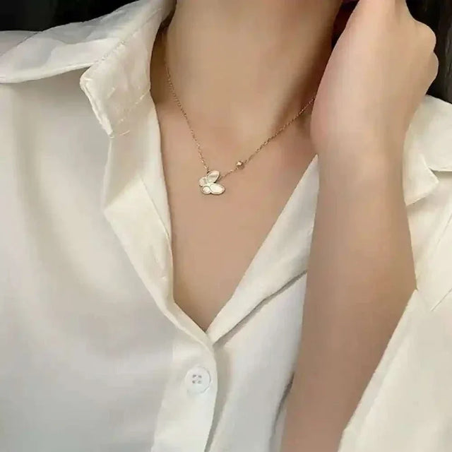 Butterfly Mother-of-Pearl Necklace with gold-plated chain worn on model in white shirt