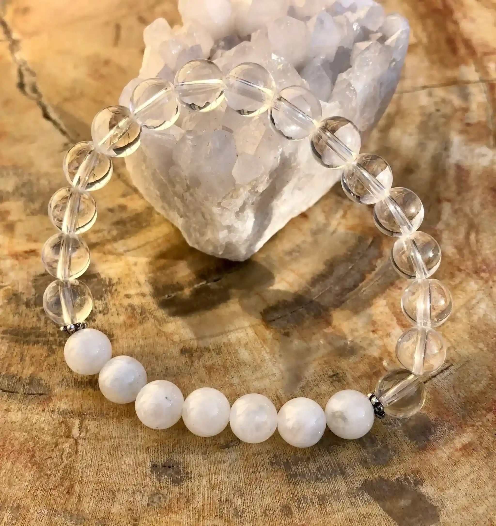 Rainbow Moonstone Stretch Bracelet with genuine moonstone and crystal quartz beads on stretch cord displayed on wooden surface