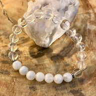 Rainbow Moonstone Stretch Bracelet with genuine moonstone and crystal quartz beads on stretch cord displayed on wooden surface