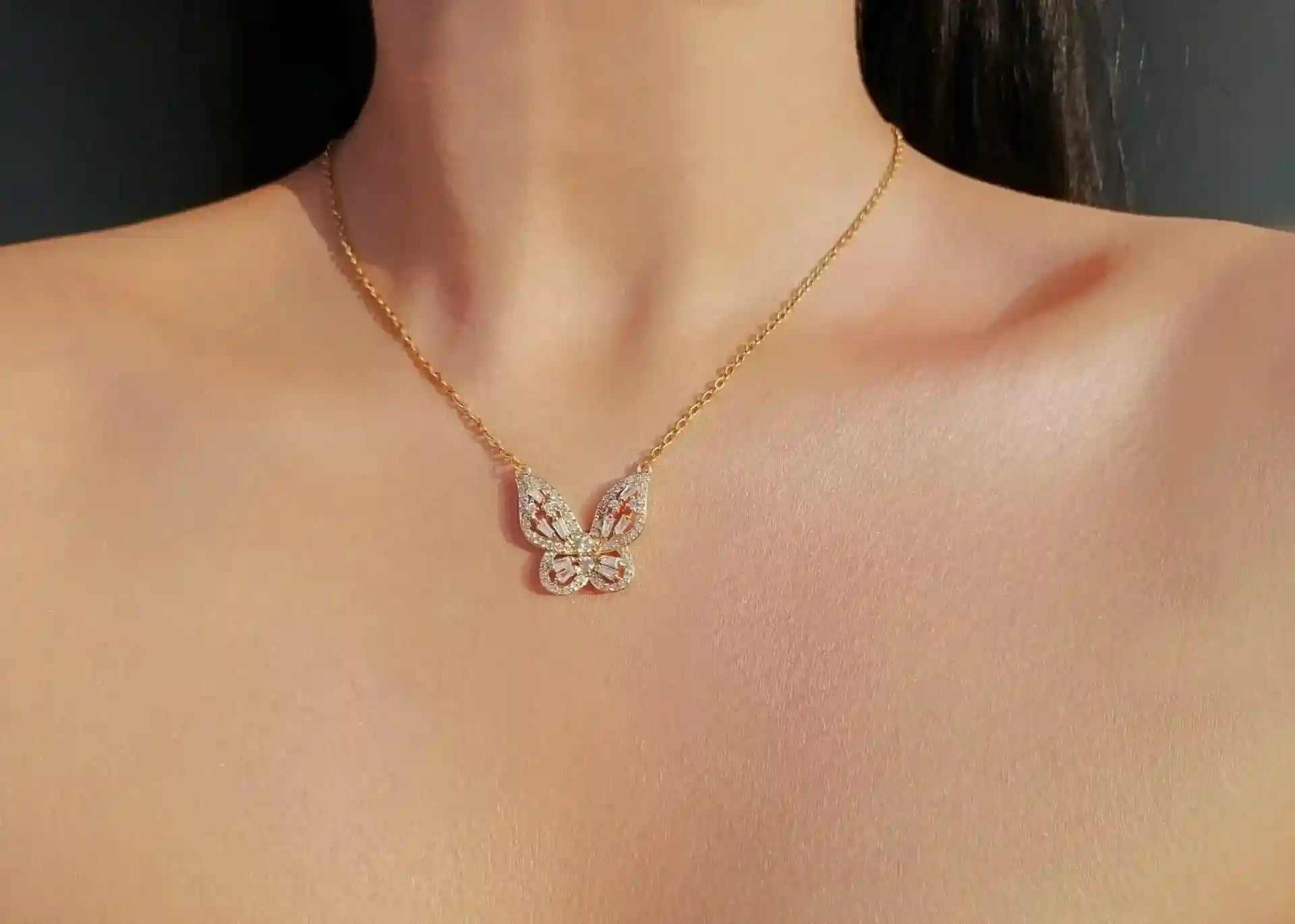 24K gold butterfly necklace with cubic zirconia pendant on adjustable chain worn on neck