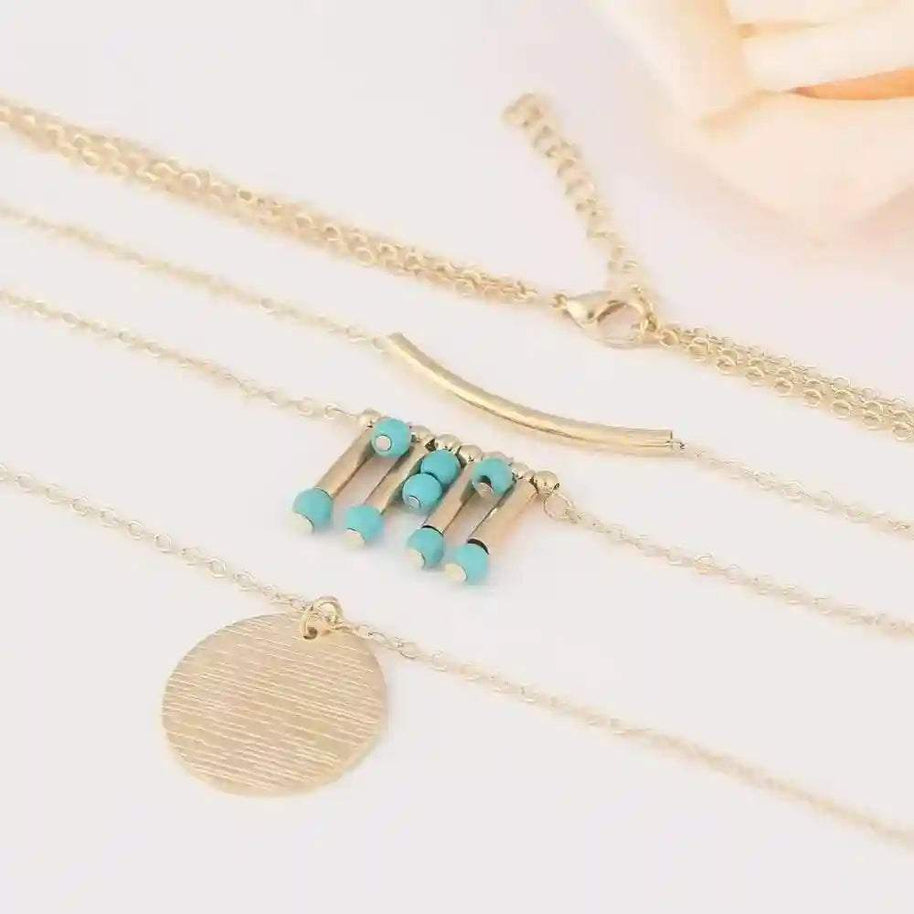 Turquoise layered necklace with gold chains and turquoise bead accents, adjustable length, boho style accessory