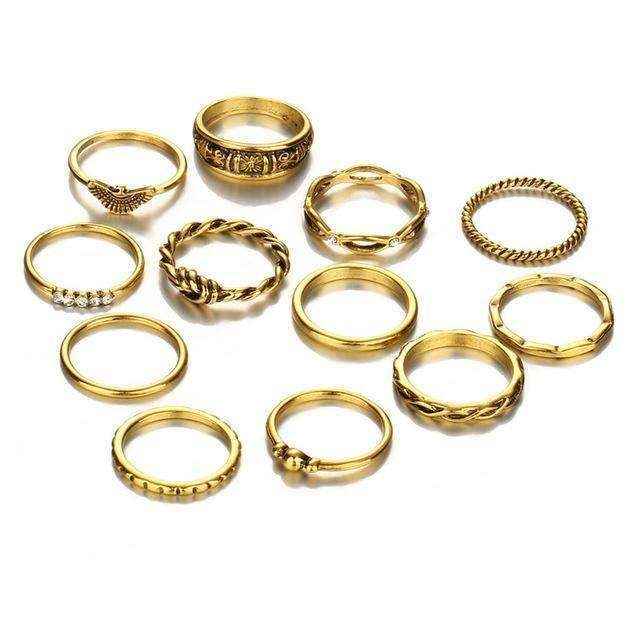 Set of twelve Golden Gem Stackable Rings with unique designs and stone accents, crafted from polished gold-toned zinc alloy for versatile layering and everyday elegance