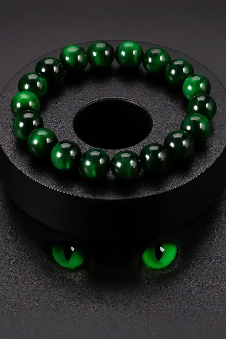 Dark bottle green bead bracelet with polished round beads on a black display against a dark background.