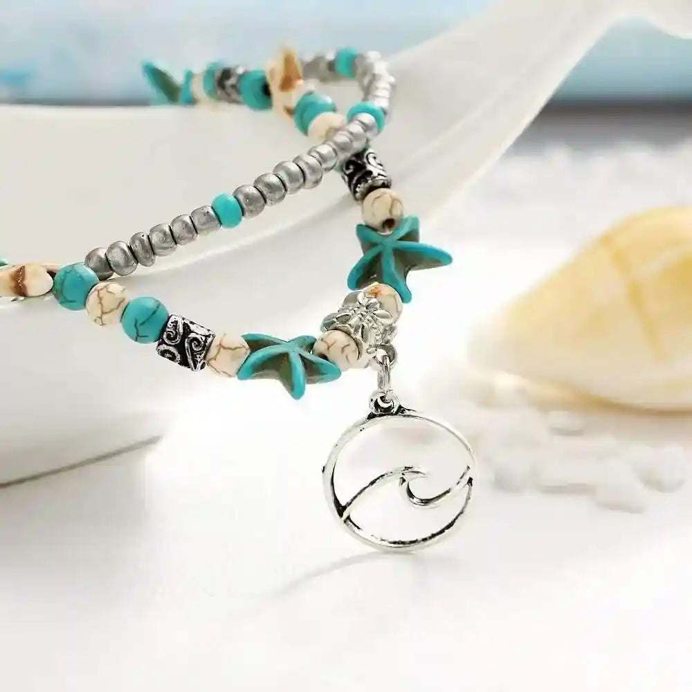 Ocean Double Layer Anklet with turquoise starfish beads and silver wave pendant, beach-inspired layered design.