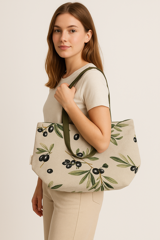 Durable Lunch Bag Mediterranean Bliss with olive branch print carried by woman, stylish cotton linen reusable lunch tote