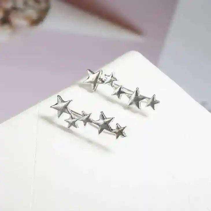 Silver star-shaped ear crawlers earrings made of durable zinc alloy with genuine stone accents, elegant and affordable accessory for single piercing.