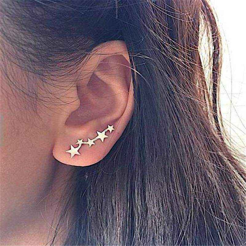 Close-up of ear wearing elegant Star Ear Crawlers with a delicate climbing star design in silver finish