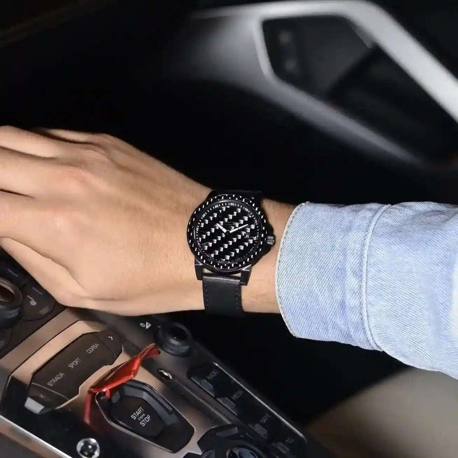 Stealth Apollo Carbon Watch with carbon fiber dial and bezel, black leather strap, worn on wrist in car interior